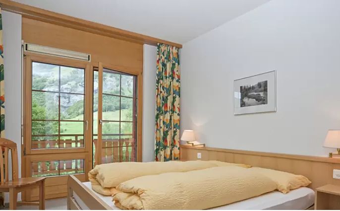Bedroom with double bed and glass door to the balcony