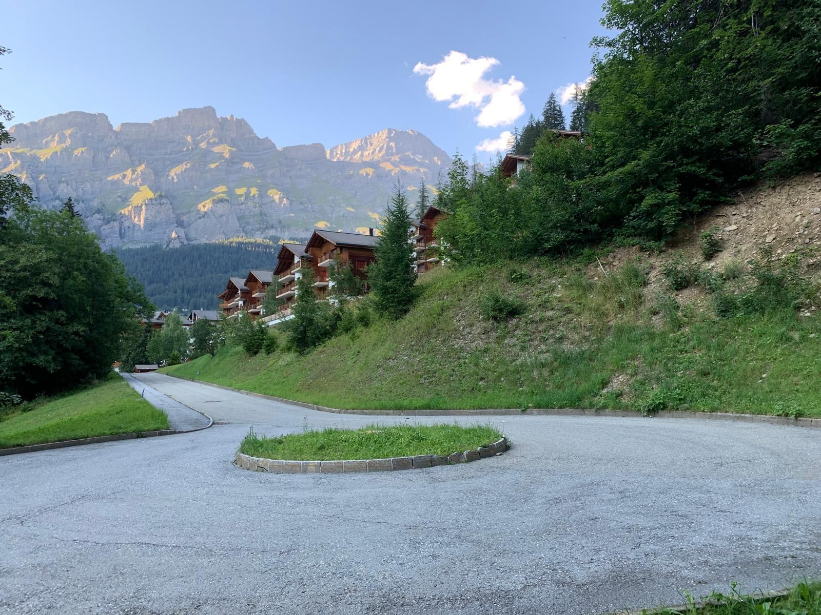 The quiet road up to the residence with cliffs behind